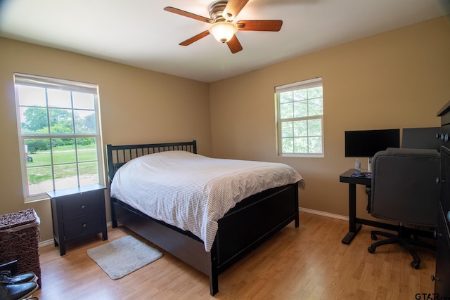 1225 S Fm 1002, Big Sandy, TX 75755 - bedroom with light wood-style floors, ceiling fan, and a desk