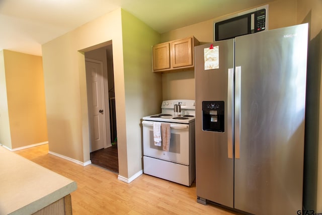 1225 S Fm 1002, Big Sandy, TX 75755 - kitchen with stainless steel fridge with ice dispenser, white range with electric cooktop, light wood-style floors, light brown cabinetry, and light countertops