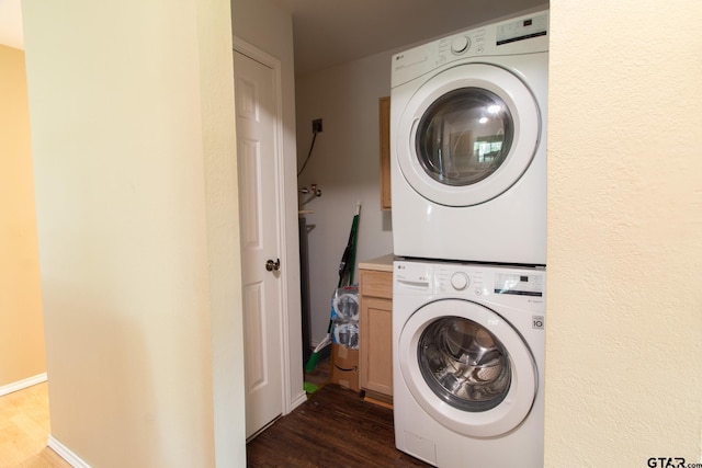 1225 S Fm 1002, Big Sandy, TX 75755 - laundry room with stacked washer and clothes dryer, dark wood-style floors, and cabinet space