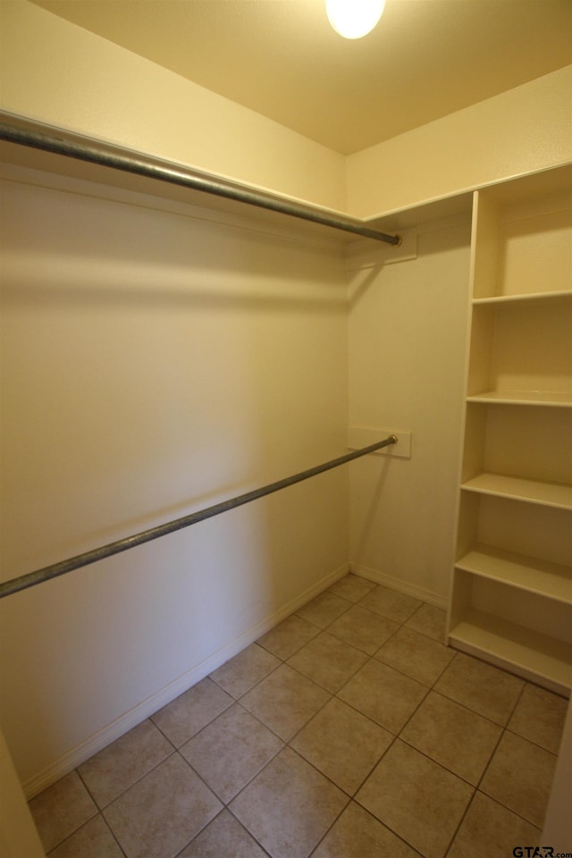 walk in closet featuring light tile patterned flooring