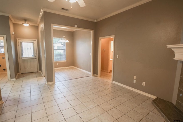 entryway featuring light tile patterned floors, ornamental molding, and ceiling fan with notable chandelier