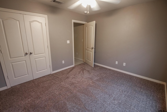 unfurnished bedroom featuring ceiling fan, a closet, and carpet floors