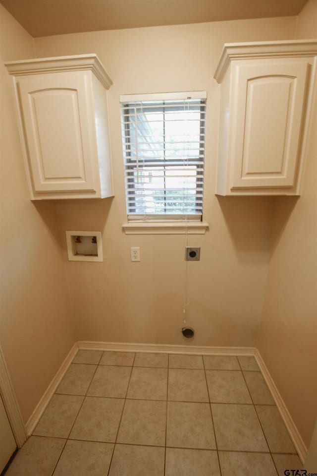 laundry area with washer hookup, cabinets, light tile patterned floors, and electric dryer hookup