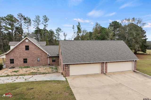 view of front of house with a front yard and a garage