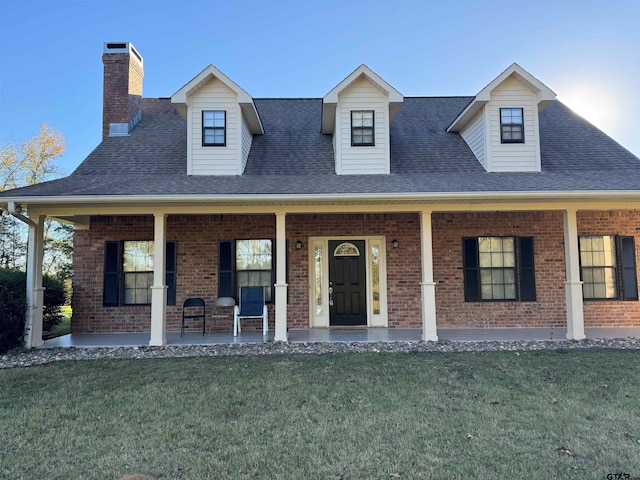 view of front of house with covered porch and a front yard