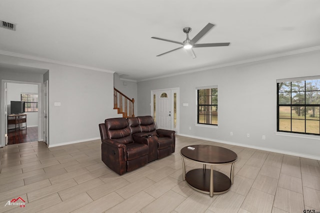 living room with ceiling fan, light wood-type flooring, and crown molding