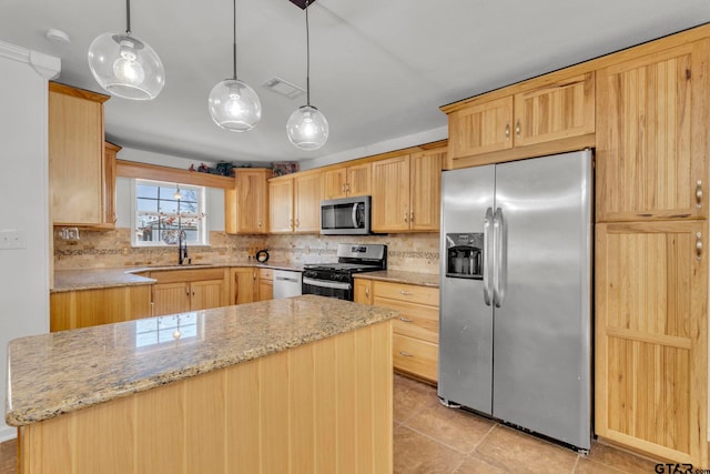 kitchen with pendant lighting, stainless steel appliances, light brown cabinets, and backsplash