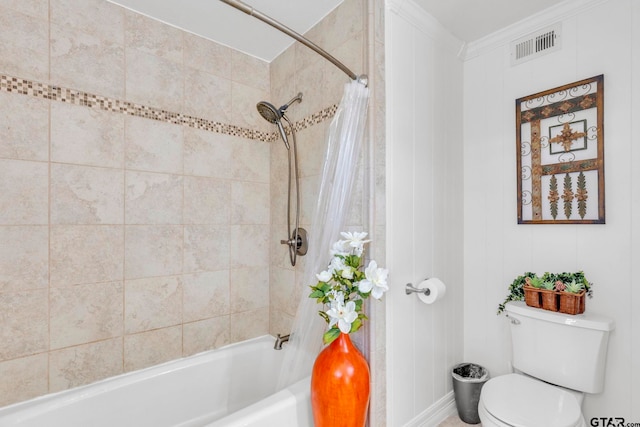 bathroom with tiled shower / bath, crown molding, and toilet