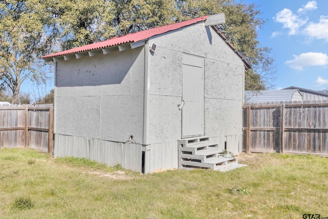 view of outdoor structure featuring a lawn