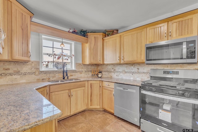 kitchen with light brown cabinetry, sink, decorative backsplash, light tile patterned floors, and stainless steel appliances