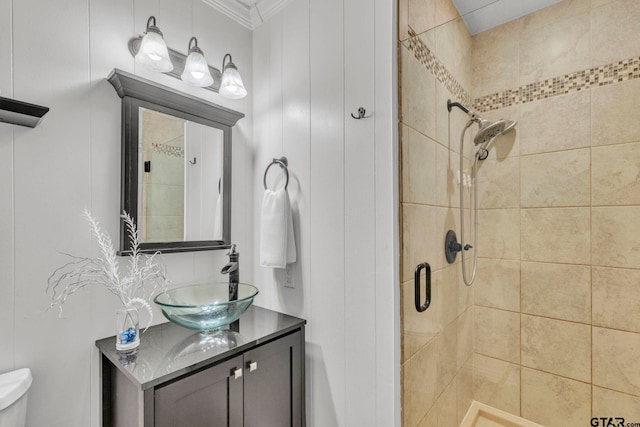 bathroom featuring vanity, an enclosed shower, crown molding, and toilet