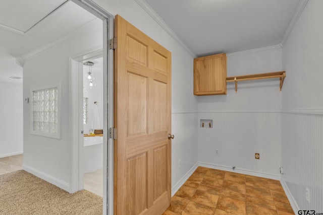 laundry area featuring crown molding, cabinets, and washer hookup