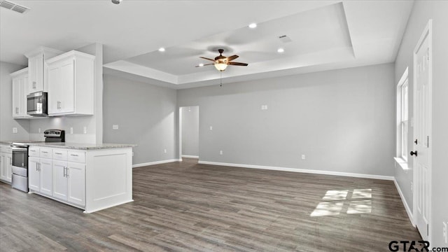 kitchen featuring visible vents, a raised ceiling, appliances with stainless steel finishes, and white cabinets