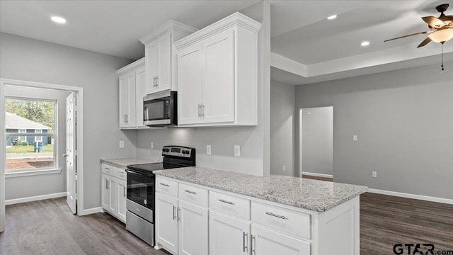 kitchen with dark wood-style floors, white cabinetry, recessed lighting, stainless steel appliances, and baseboards