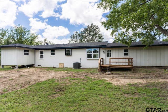 back of property featuring a lawn, central air condition unit, and a deck