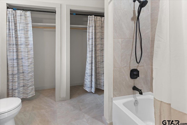 bathroom featuring tile patterned floors, toilet, and shower / bath combo with shower curtain