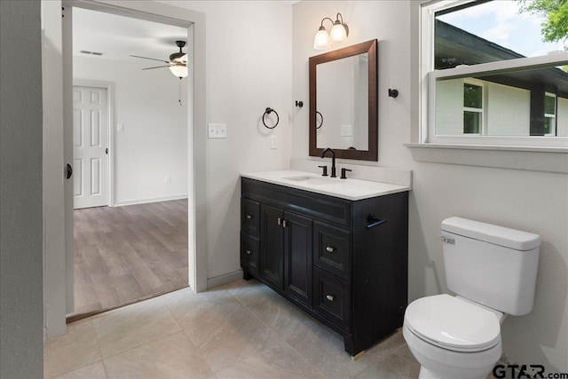 bathroom with vanity, ceiling fan, tile patterned floors, and toilet