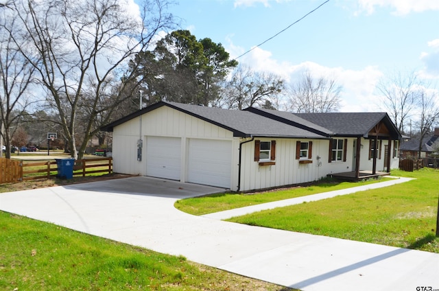 ranch-style house featuring a garage and a front lawn