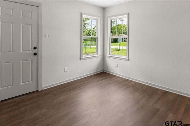 unfurnished room with dark hardwood / wood-style flooring