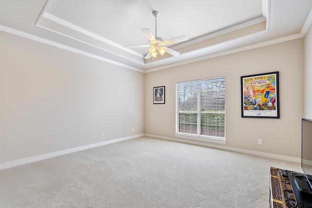 2213 Woodlands Dr, Tyler, TX 75703 - unfurnished room featuring a raised ceiling, carpet floors, ceiling fan, crown molding, and baseboards