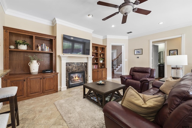 2213 Woodlands Dr, Tyler, TX 75703 - living area with a premium fireplace, ornamental molding, ceiling fan, stairway, and recessed lighting