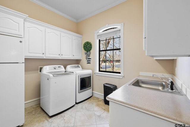 2213 Woodlands Dr, Tyler, TX 75703 - laundry area with cabinet space, washing machine and dryer, crown molding, baseboards, and light marble finish floors