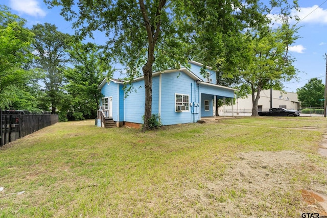 exterior space with fence and a front yard