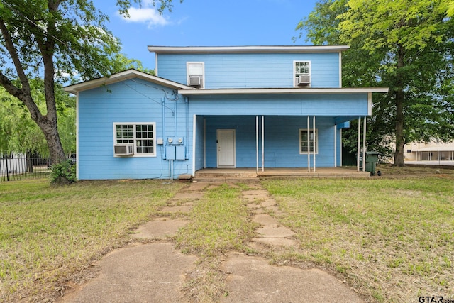 view of front of home featuring a porch, fence, cooling unit, and a front yard