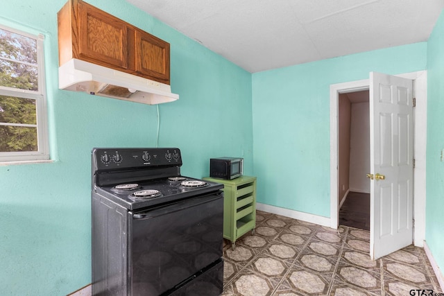 laundry area with light floors and baseboards