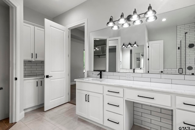 bathroom with vanity, decorative backsplash, tile patterned floors, and a shower with shower door