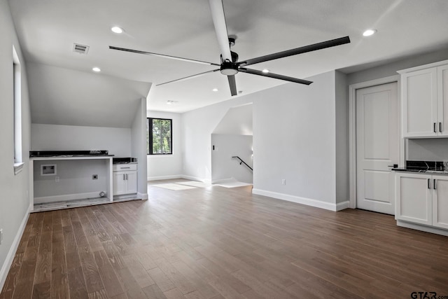 bonus room featuring dark wood-type flooring, ceiling fan, and lofted ceiling