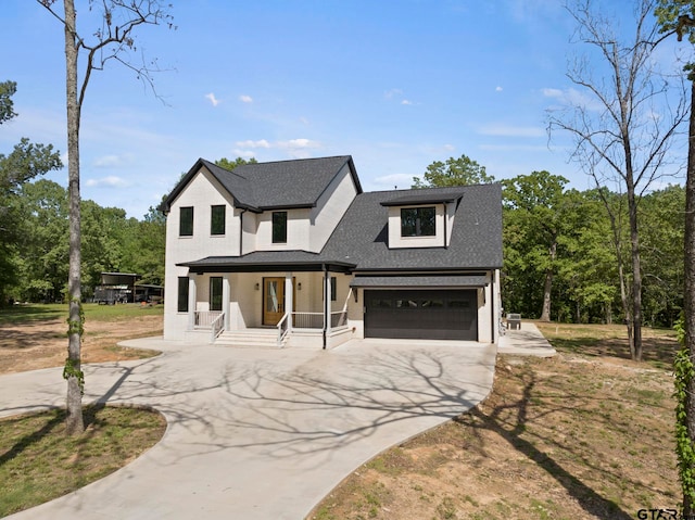 view of front facade with a garage and covered porch