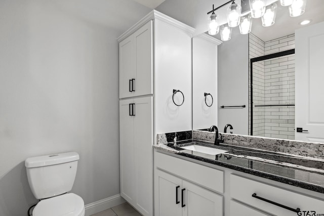 bathroom featuring an enclosed shower, vanity, tile patterned floors, and toilet