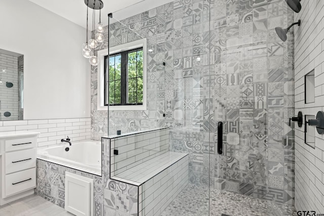 bathroom with vanity, independent shower and bath, and tile walls