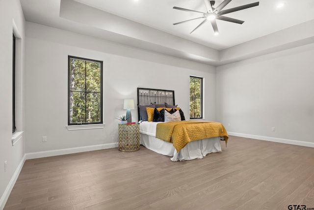 bedroom with light hardwood / wood-style floors and ceiling fan