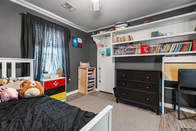 bedroom featuring ceiling fan, hardwood / wood-style floors, and ornamental molding