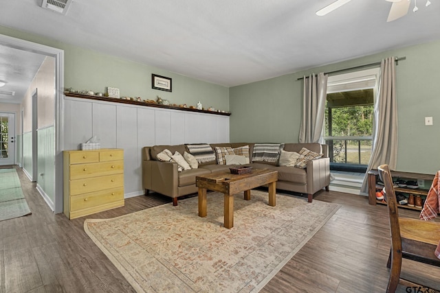 living room featuring dark hardwood / wood-style flooring and ceiling fan