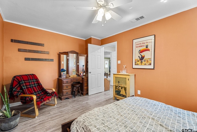 bedroom with ornamental molding, hardwood / wood-style floors, and ceiling fan