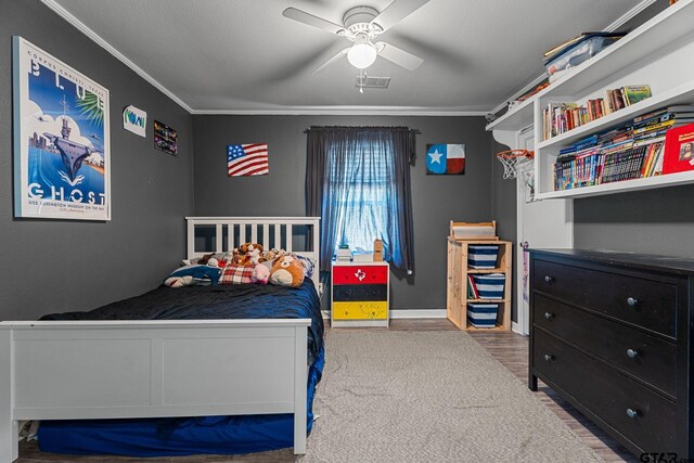 bedroom featuring ornamental molding, hardwood / wood-style floors, and ceiling fan