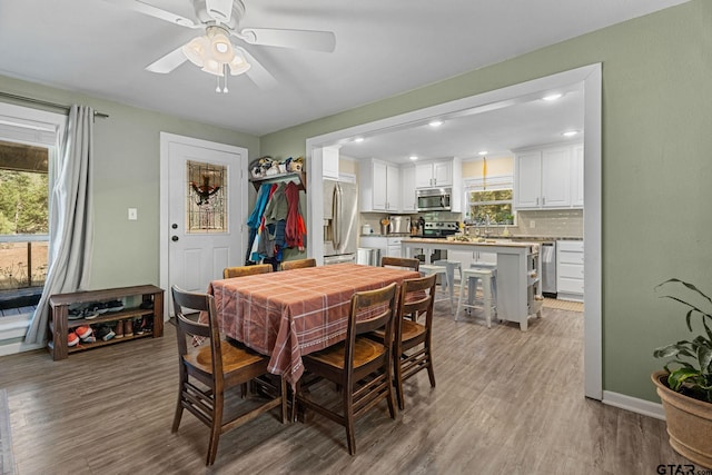 dining room featuring light wood-type flooring and ceiling fan