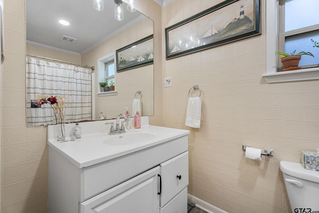 bathroom featuring walk in shower, vanity, toilet, and crown molding