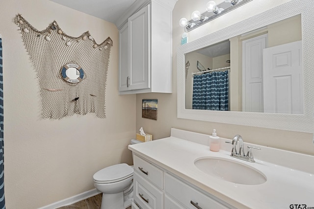 bathroom featuring vanity and toilet