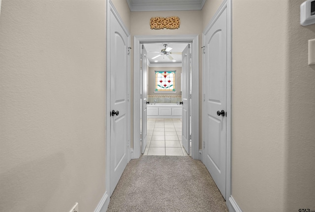 corridor featuring light carpet and ornamental molding