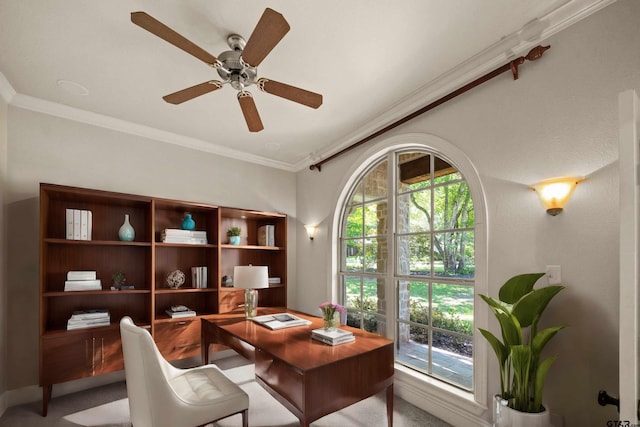 home office featuring carpet, ceiling fan, and crown molding