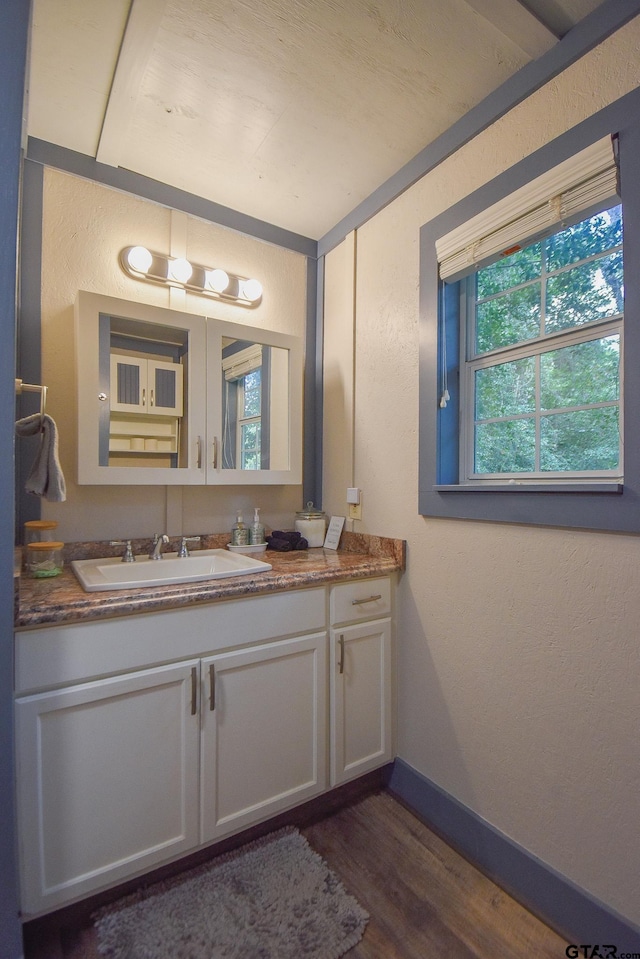21171 Sand Jack Rd, Larue, TX 75770 - bathroom featuring vanity, a textured wall, wood finished floors, and baseboards