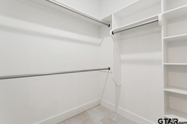 spacious closet with light tile patterned floors