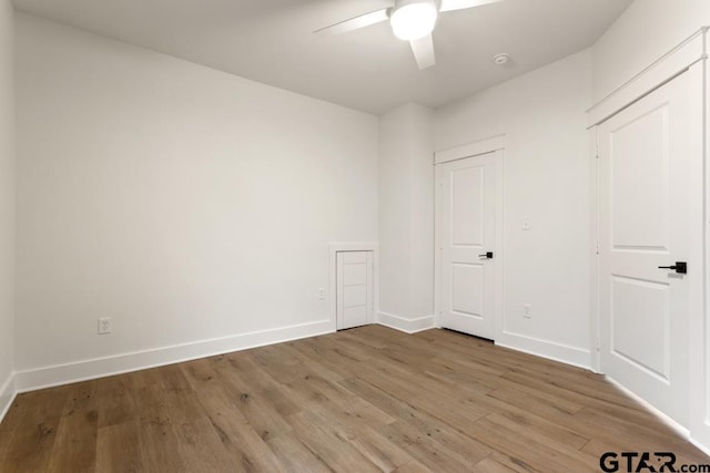 empty room with hardwood / wood-style flooring and ceiling fan