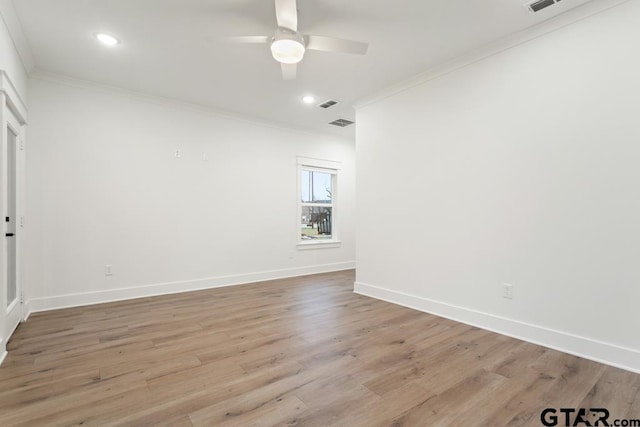 empty room with ceiling fan, ornamental molding, and light wood-type flooring