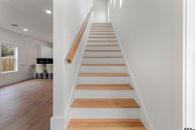 staircase with hardwood / wood-style floors