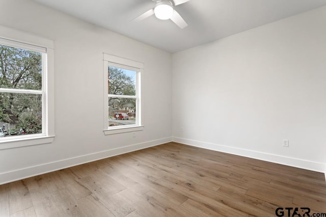 spare room featuring hardwood / wood-style flooring and ceiling fan